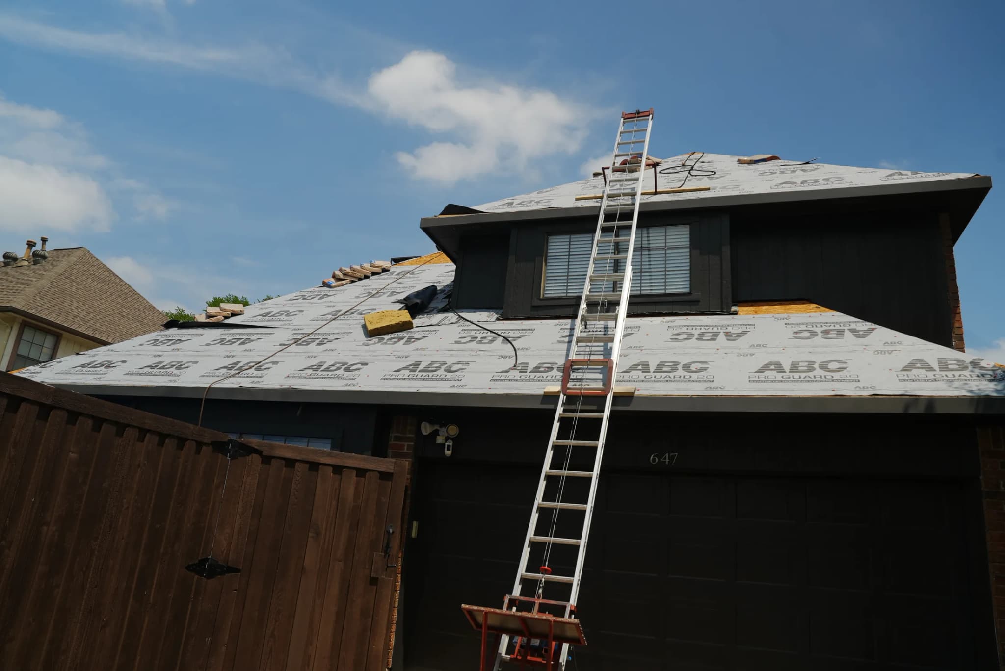 JRH Construction installing ABC ProGuard synthetic underlayment on residential roof in Allen TX