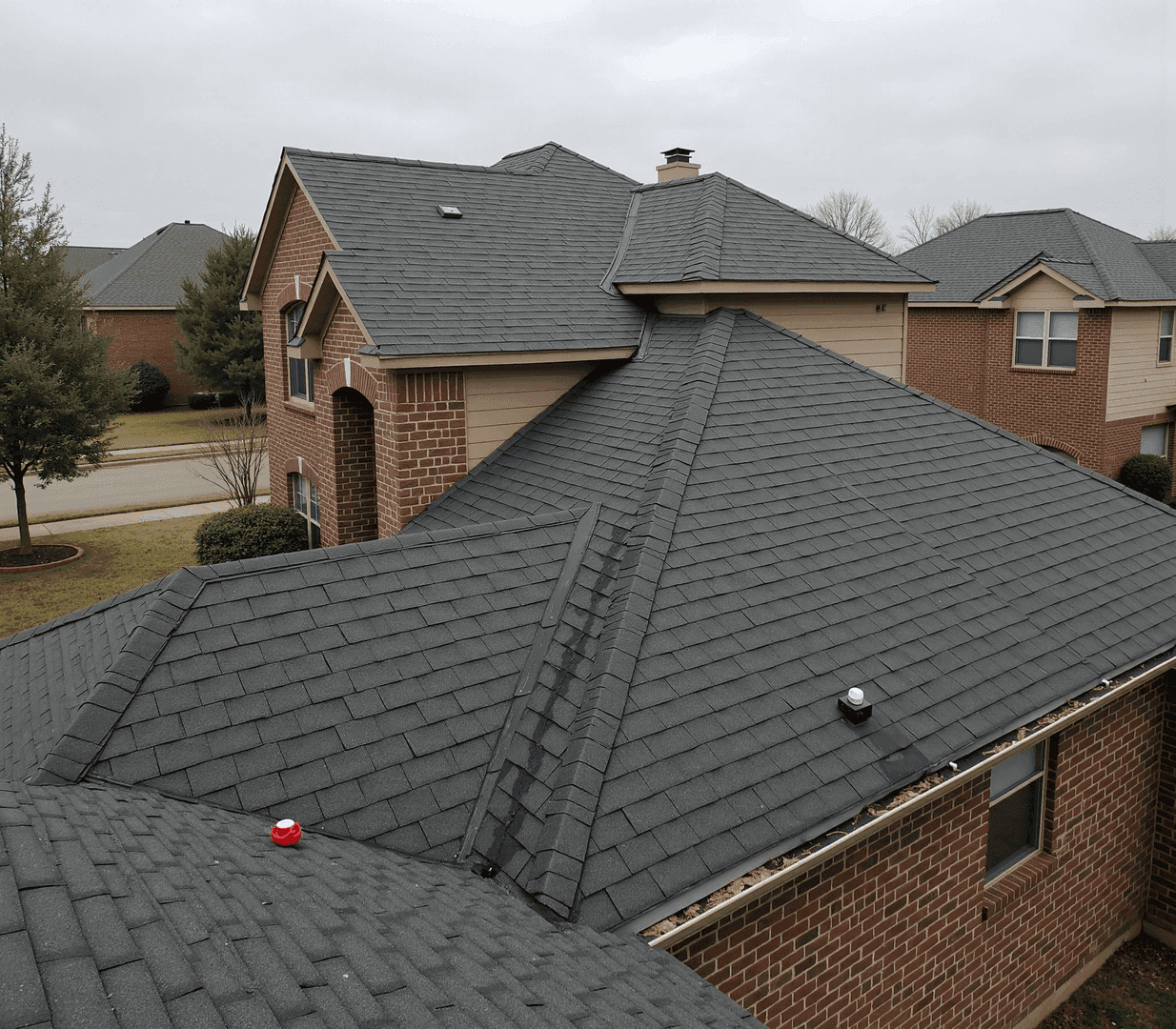 Same home with brand new charcoal architectural shingles by JRH Construction