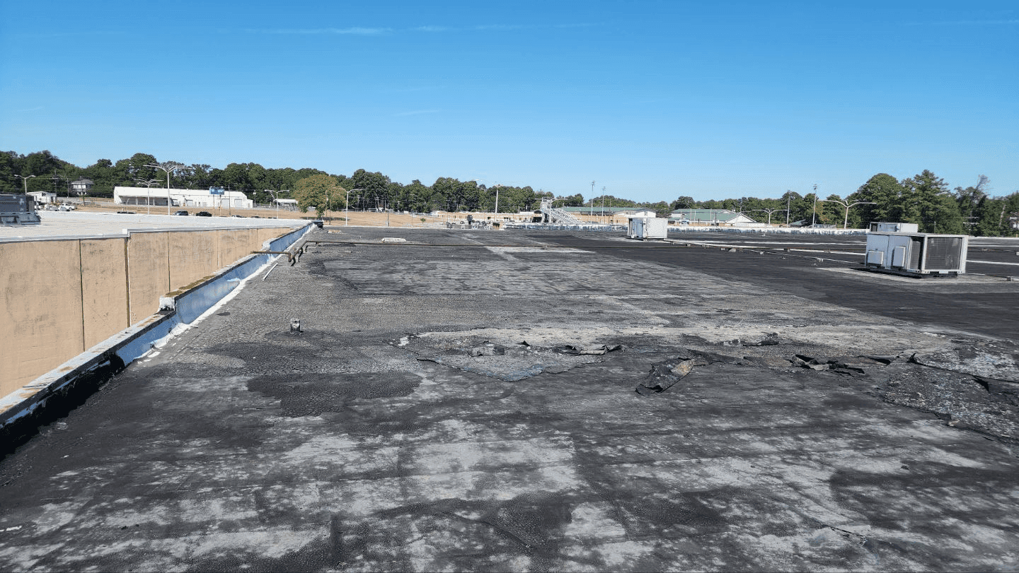 Damaged commercial flat roof before JRH Construction replacement