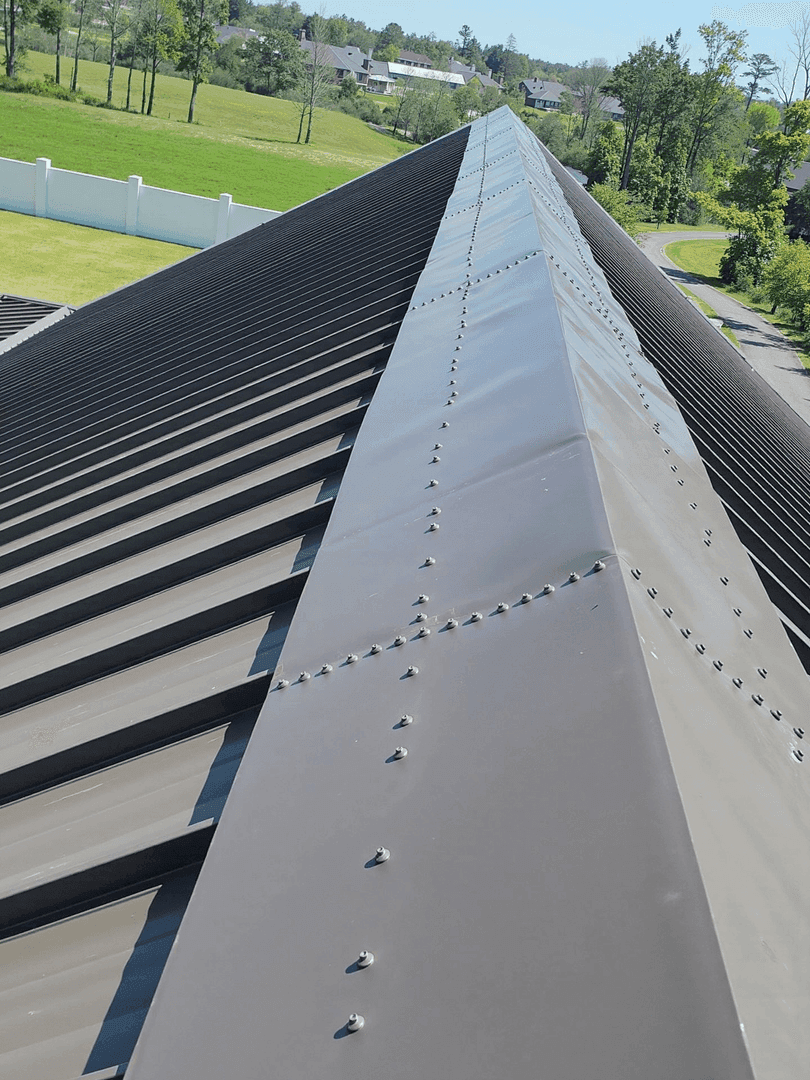 Standing seam metal roof ridge by JRH Construction